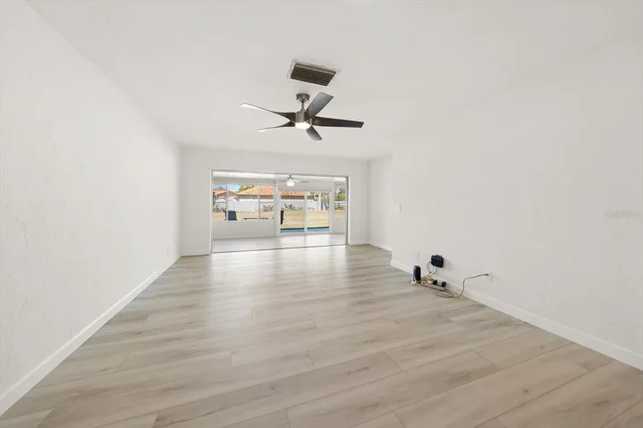 large open living room, dining room combo with sliders out to the Florida room