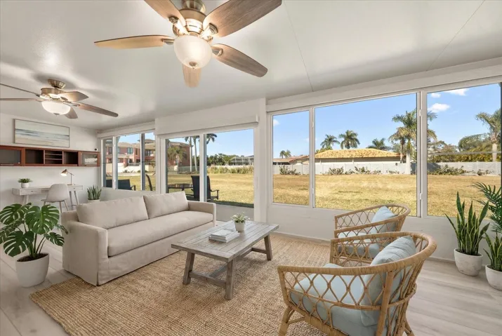 Florida room - virtually staged - all windows and doors are hurricane rated. - Perfect place to relax and enjoy the greenspace, water views and sunsets