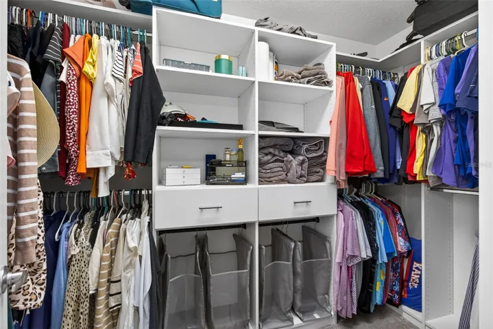 Primary closet with custom built in shelving
