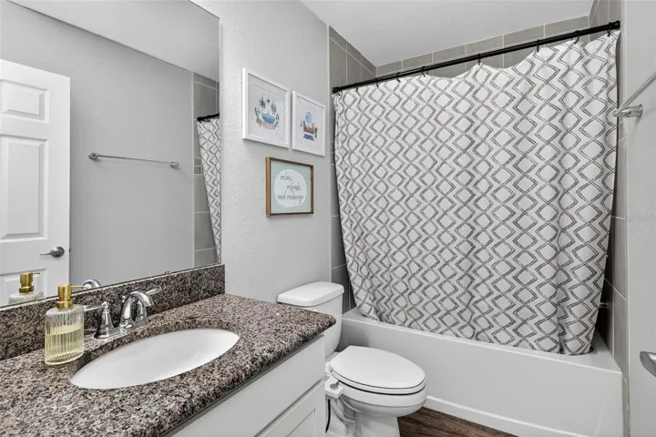 Bathroom 3 features granite counter top and tub/shower combination