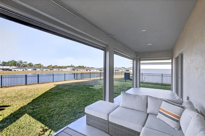 Covered back porch features electric screens!