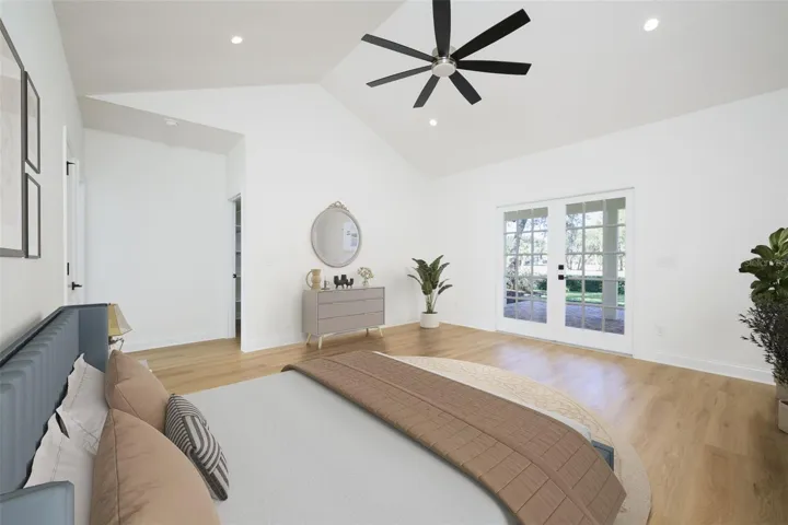 Primary Suite with French doors to covered lanai overlooking golf course.