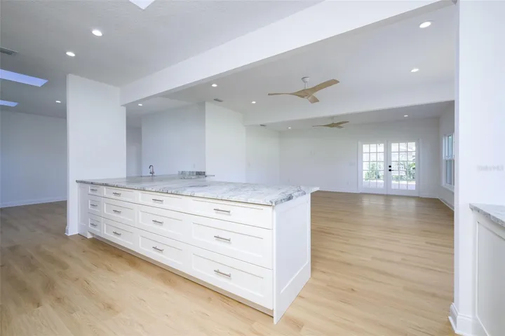 Gourmet Kitchen with breakfast bar overlooking dining room, living room, and family room w/fireplace.