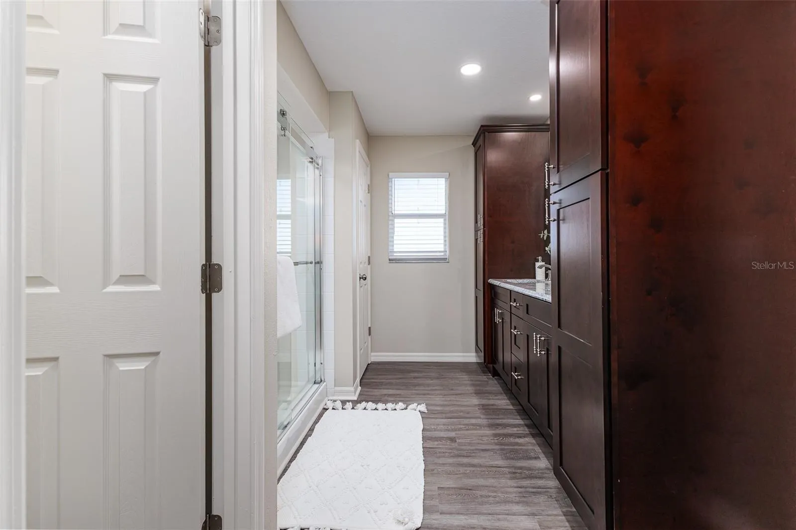 En Suite Primary Bath with Shower, dual sinks, stone countertops, plenty of storage, great lighting, and walk-in-closet, and water-closet toilet room.