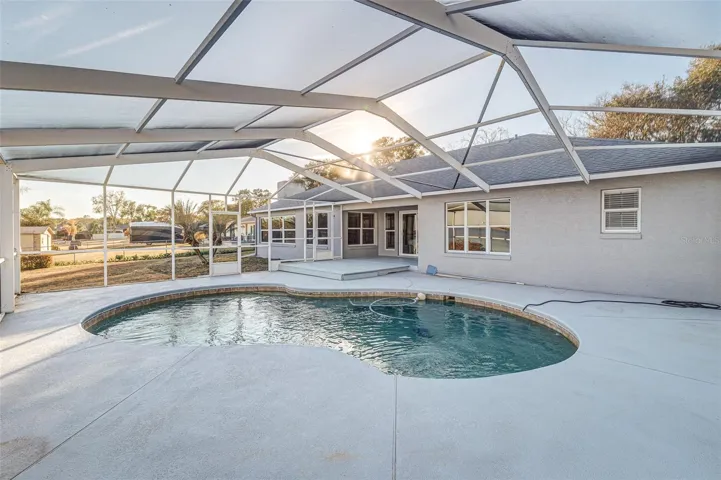 Pool deck featuring covered screened enclosure; expansive views of Lake Agnes