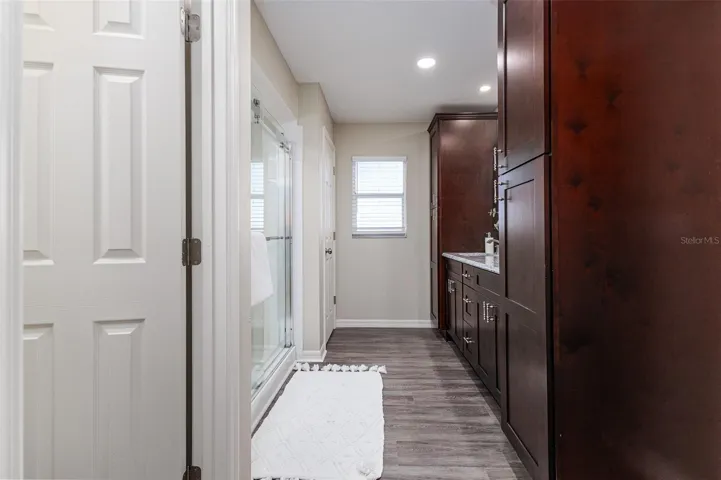 En Suite Primary Bath with Shower, dual sinks, stone countertops, plenty of storage, great lighting, and walk-in-closet, and water-closet toilet room.