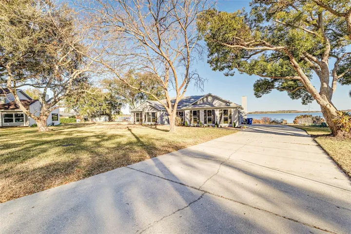 View from Driveway showing plenty of parking spaces, view of Lake Agnes, house, mature trees