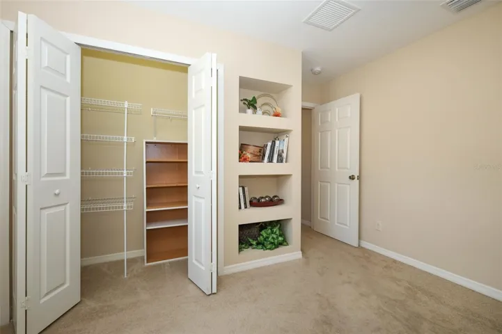 Secondary Bedroom with built in closet and built in shelving