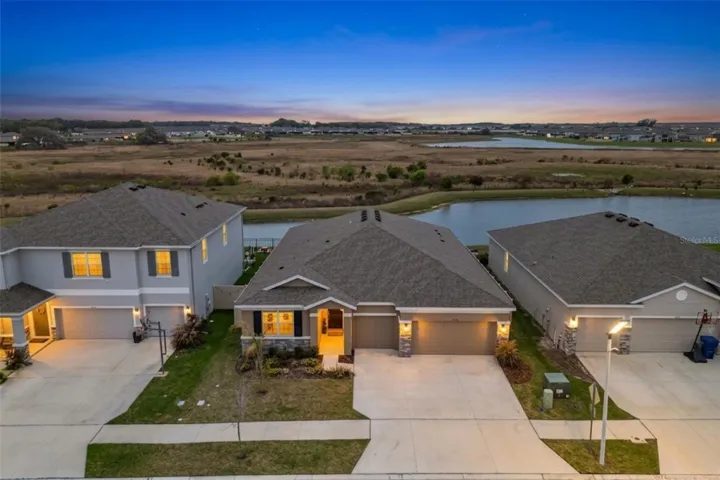 Stunning curb appeal set on a premium pond lot with wide, sparkling water views and beautifully maintained landscaping.