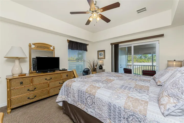 Primary bedroom has sliding glass doors opening onto the lanai