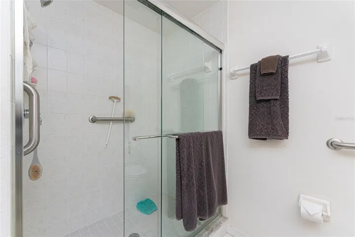 Primary bath has nice step in shower with door.