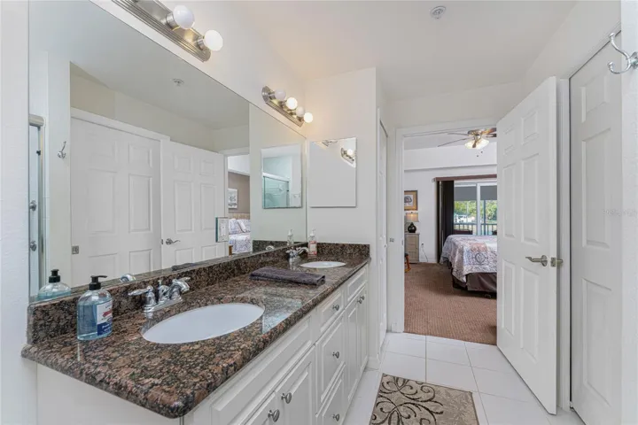 Primary bath has a double basin vanity w/granite top