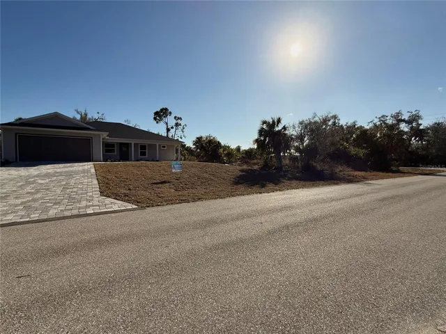 View of new construction home for sale adjacent to lot (lot to the right of home in this image).