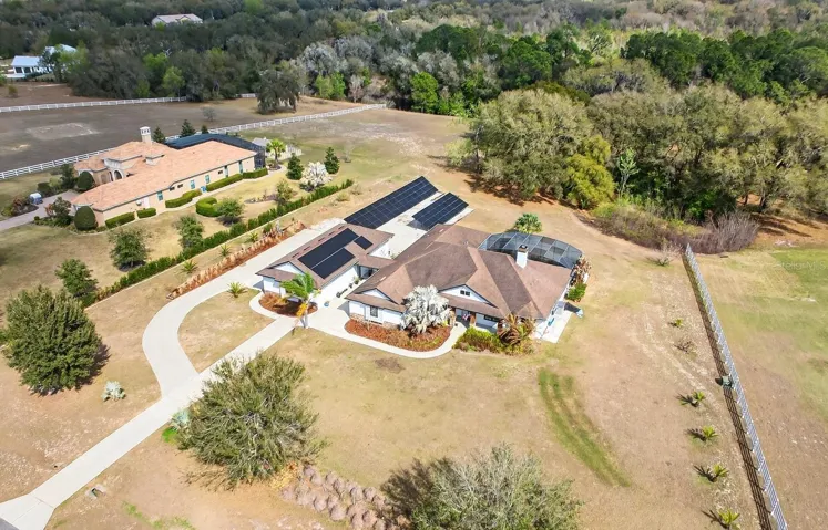 Set on 2.32 PICTURESQUE ACRES inside the GATED ~ EQUESTRIAN COMMUNITY of Beauclair Ranch Club, this CUSTOM BUILT ~ 6-bedroom / 4-bath ~ POOL HOME with a 4-car detached garage offers the perfect blend of privacy, luxury, and energy-efficient living!