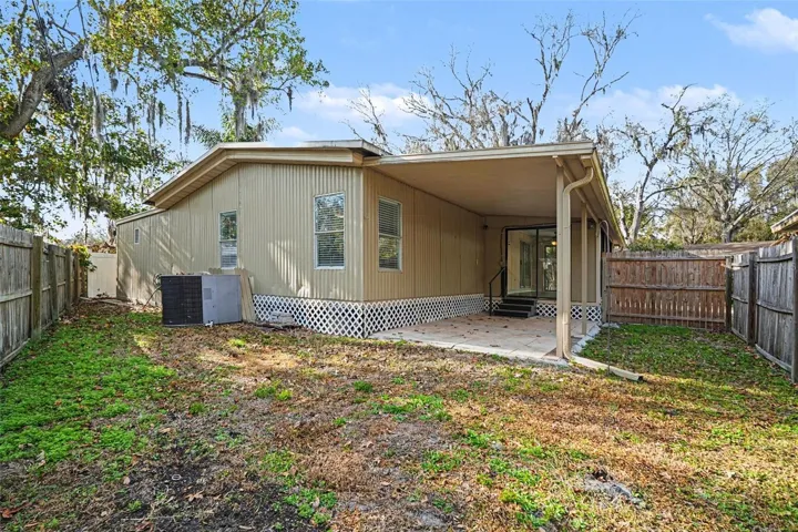 The backyard features a pavered patio and room for the pets and kids to run