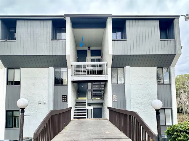 xterior view of condo offering added privacy and convenient access with open parking nearby.