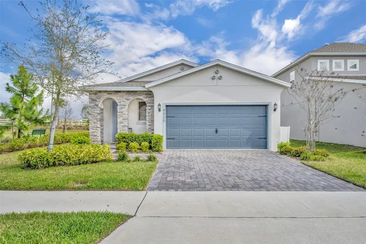 Front exterior of 4426 Davos Drive in Hartwood Landing featuring block and stucco construction and single-story design.