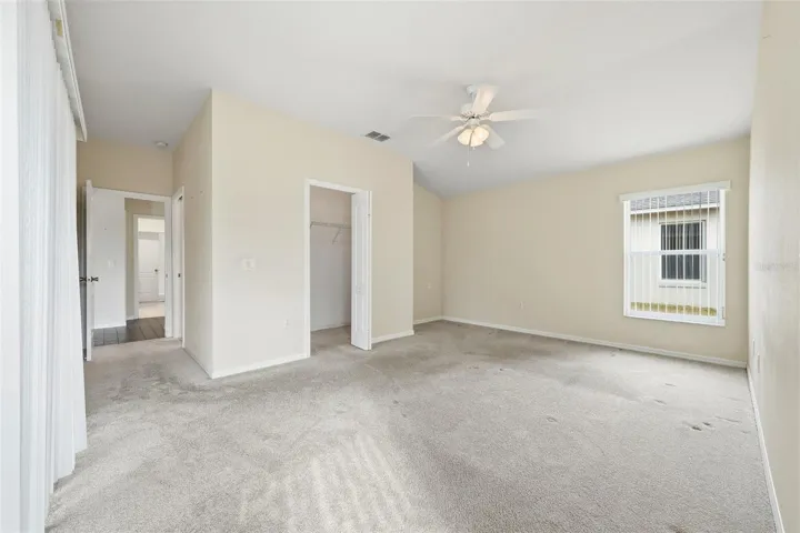 Primary Bedroom with walk-in closet and sliding doors to lanai