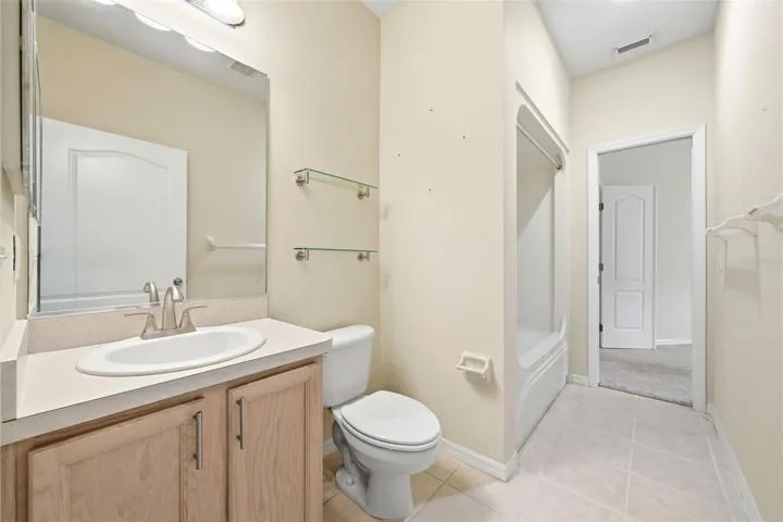 Guest Bath with tub/shower combination and one door to hallway next to Bedroom 2 and one door to office/den or possibly third bedroom suite