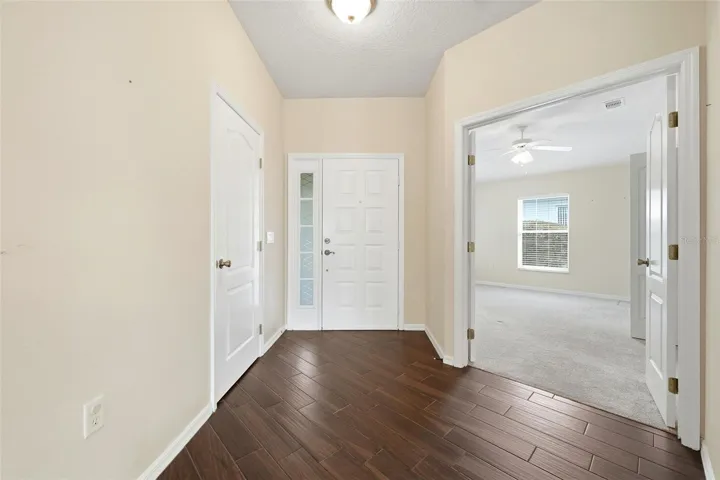 Inside entrance with coat closet and double doors to office/den or third bedroom