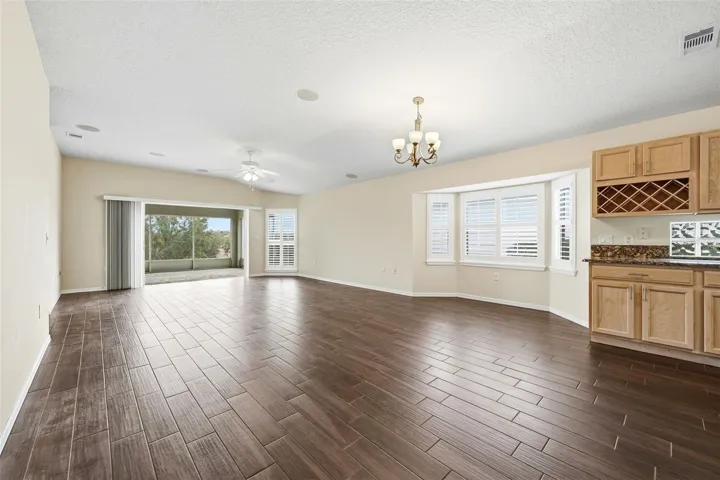 Dining area with bay windows...plantation shutters...kitchen built-in wine rack!