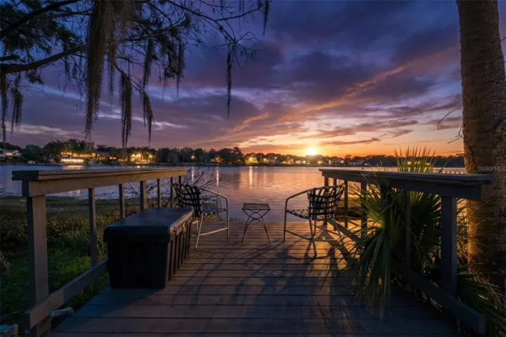 Private waterfront deck and beach area to relax and enjoy sunsets.Photo is virtually enhanced.