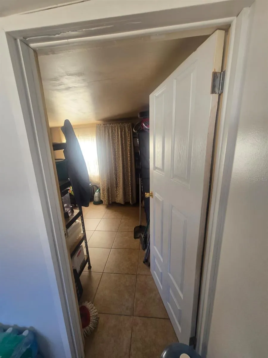 Door on the right of the mudroom towards storage area room