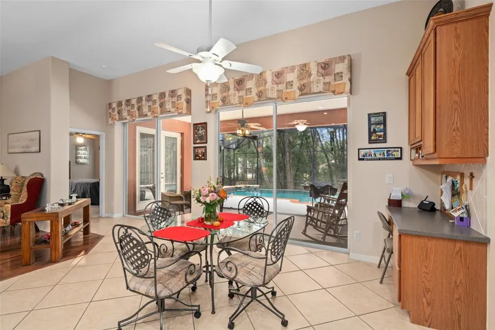 Dinette with a beautiful view of the Infinity Edge Pool and the wooded rear yard