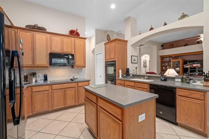 Kitchen with Built-in Double Ovens and a Cooktop with 2 Pantry's