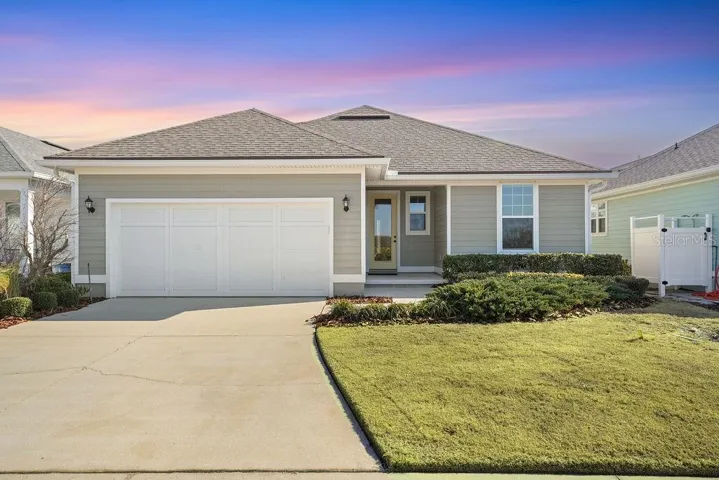 REAR OF HOME AND DRIVEWAY