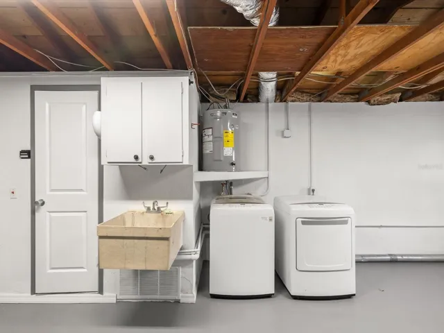 Garage sink and laundry area, bathroom to the right of this photo with toilet and shower