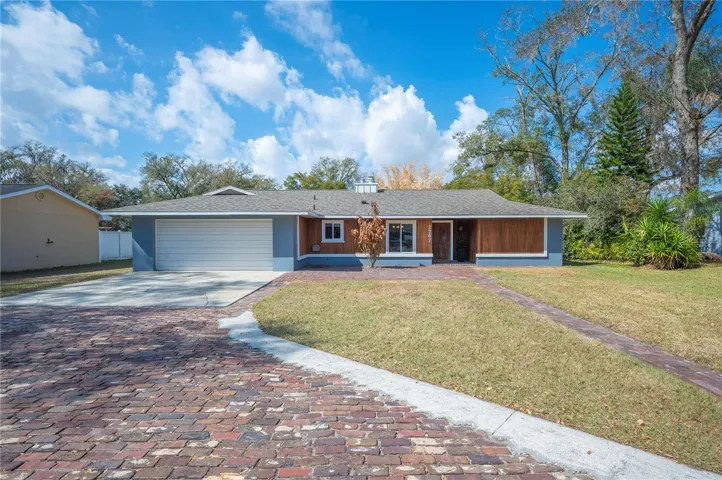 Front of house with brick driveway