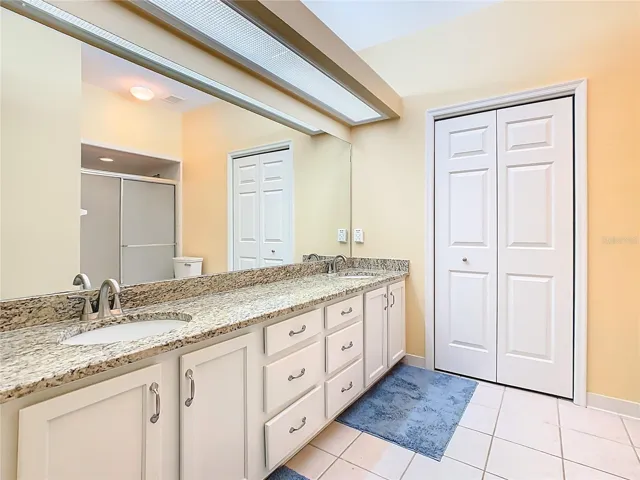 Primary Bathroom with Dual Sinks and Granite Counter Tops