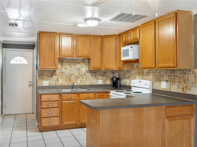 Lots of cabinets and beautiful backsplash