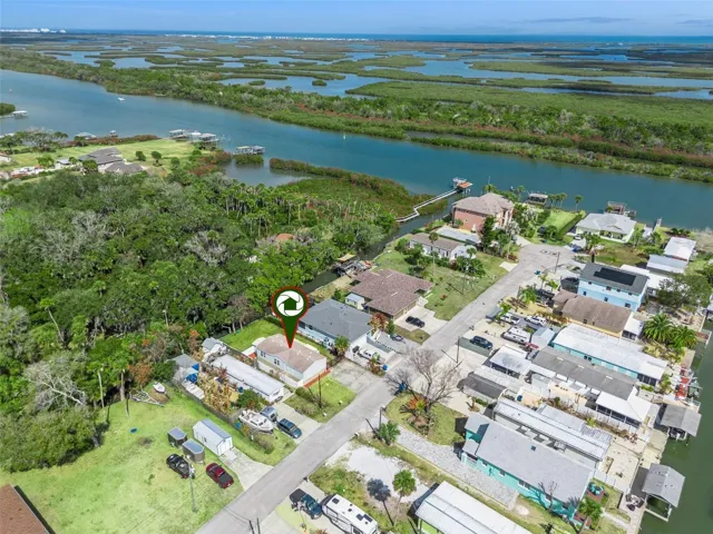 Aerial Wide Showing Canal Behind home and Indian River to East