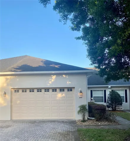 front with two car garage and paver driveway.