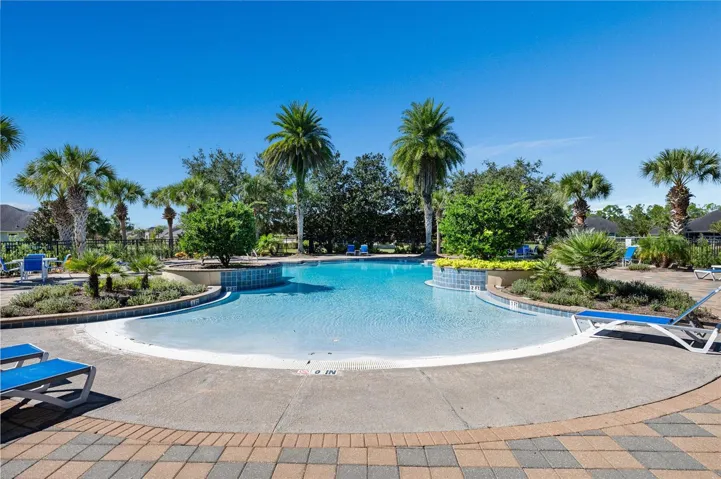 Community pool, lounge chairs await