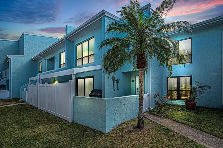 Evening shot of the front entry with fenced pato area