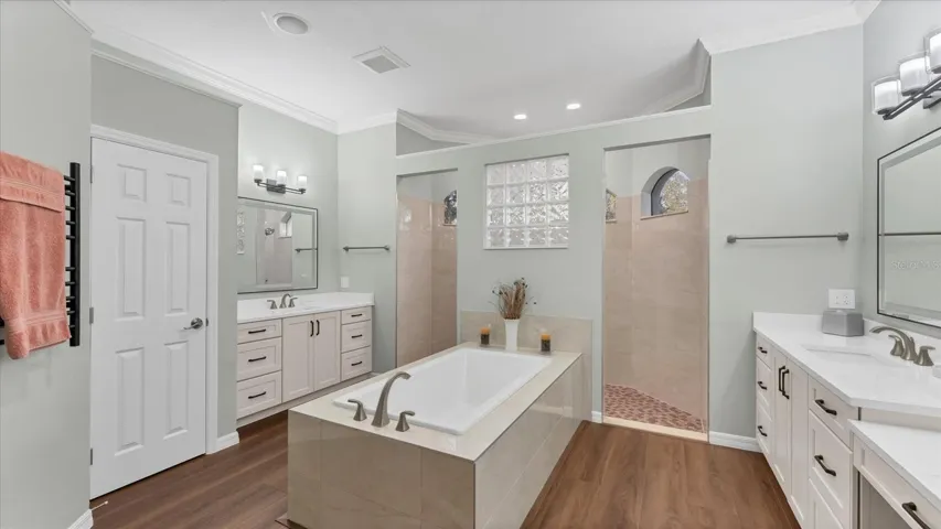 Relax in your spa inspired bathroom featuring modern finishes. Walk-in shower with dual shower heads, vanity area, dual sinks with upgraded mirrors, heated towel bar and relaxing soaking tub.