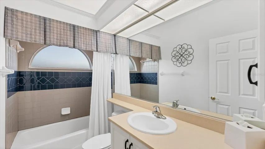Guest bathroom upstairs with tub/shower combination.