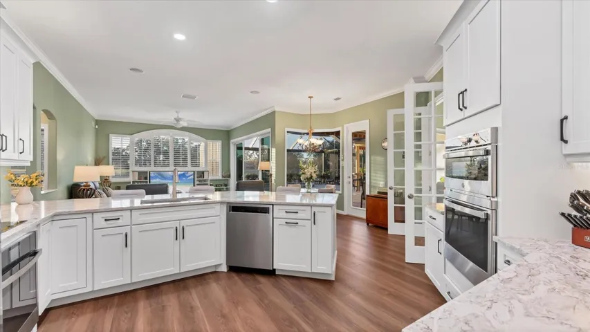 Remodeled kitchen offers stainless steel appliances, generous countertop space, a custom-fitted pantry, and a dedicated coffee/wine bar, creating both functionality & style.