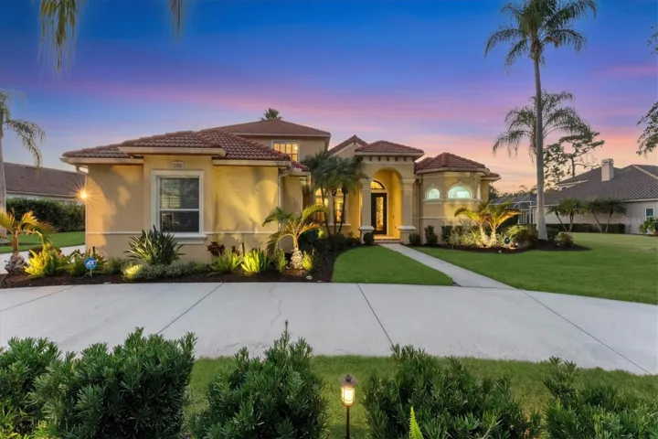 Meticulously maintained mature landscaping with professional landscape lighting.