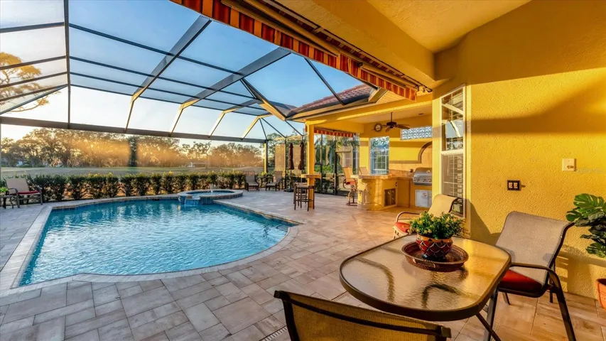 The outdoor space is exceptional! Enjoy a saltwater pool & spa, outdoor kitchen, & convenient pool bath, all within clearview panel screened lanai.  Retractable lanai awnings offer added shade when desired.