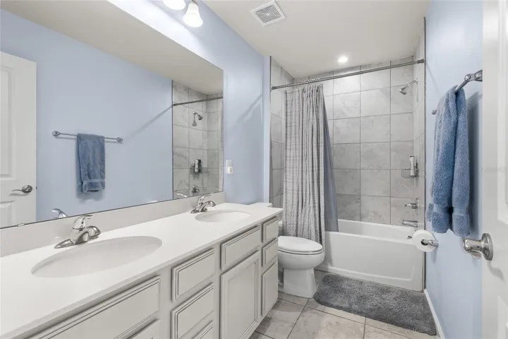 Upstairs hall bath features double sinks for no fighting over space, and a deep tub shower combo