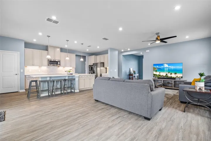 Family room into kitchen showing large breakfast bar in island