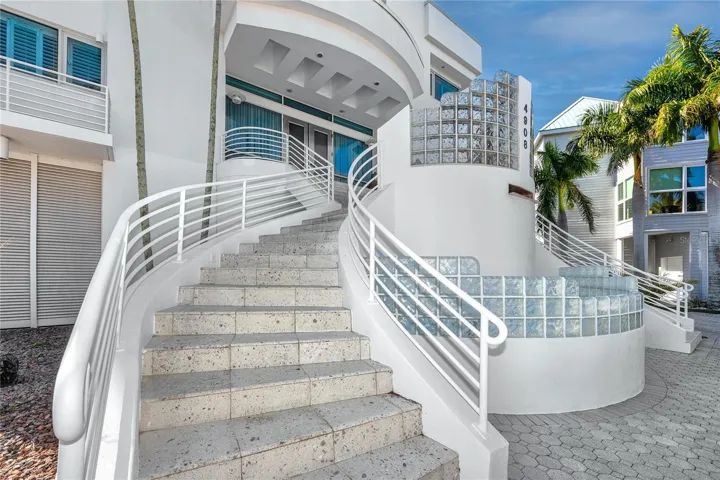 Sweeping double staircase to 2nd level front door