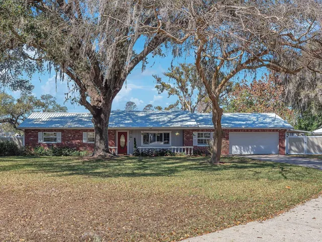 4 Bed 2 Bath beautifully remodeled home sits on a full acre with 160 feet of shoreline along Valrico Lake.