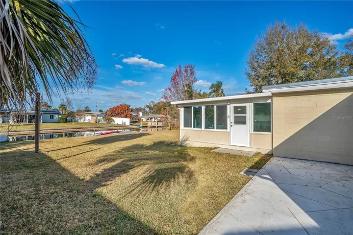 Back deck outside primary bathroom with canal view and view of bonus room door.
