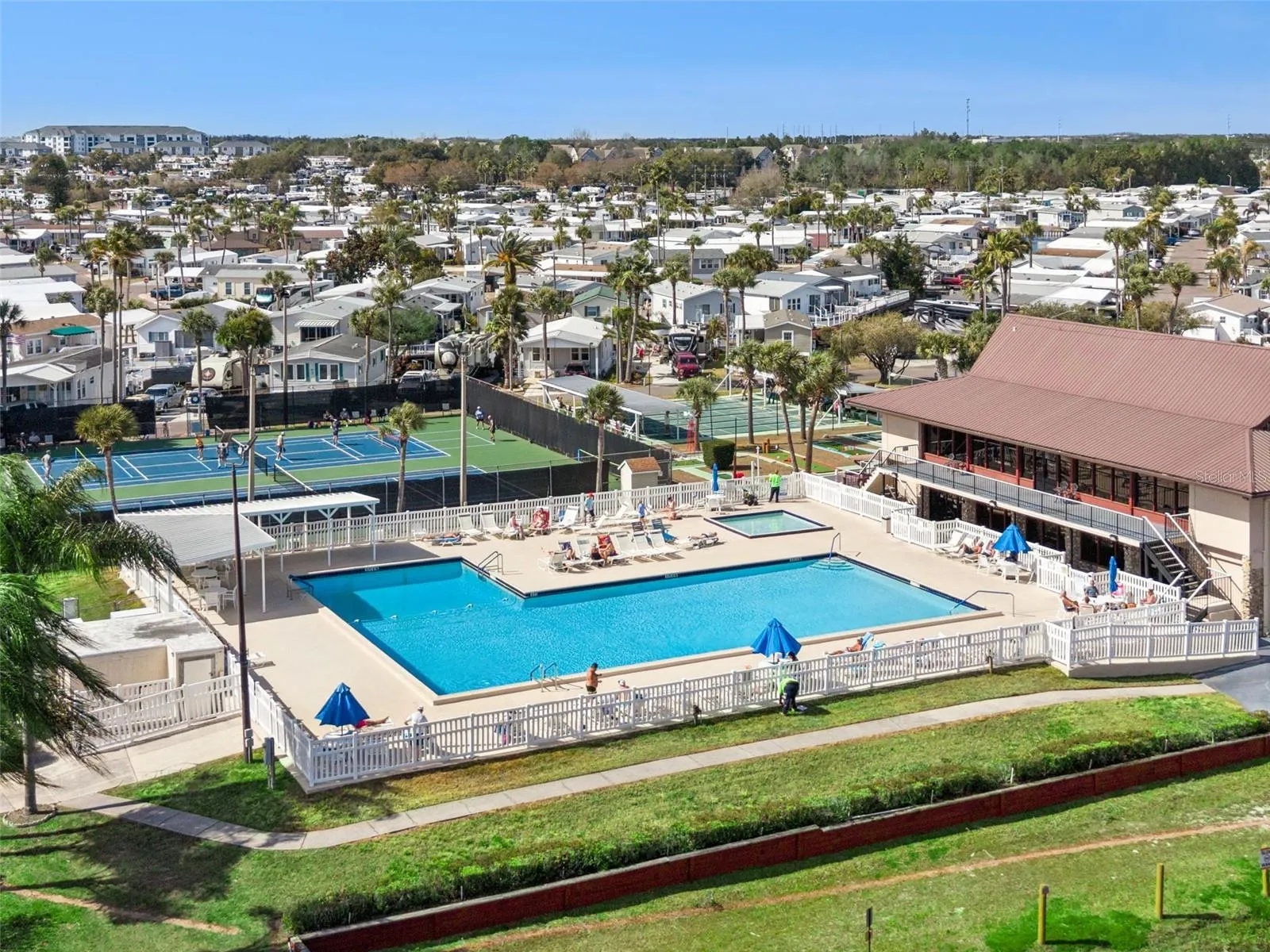 Clubhouse with community pool and tennis/pickleball courts