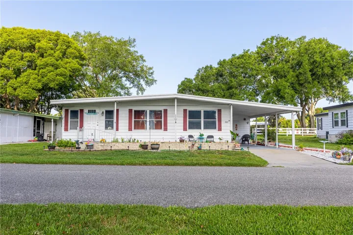 2bdrm 2 Bath double wide home 1368 sq ft of living space.  Nice size lot with driveway and carport, both front and side entries. Close to Main Depot Community Complex and easy in and out access to main gate.  (Photo taken before the 2026 Central FLorida Freeze.)